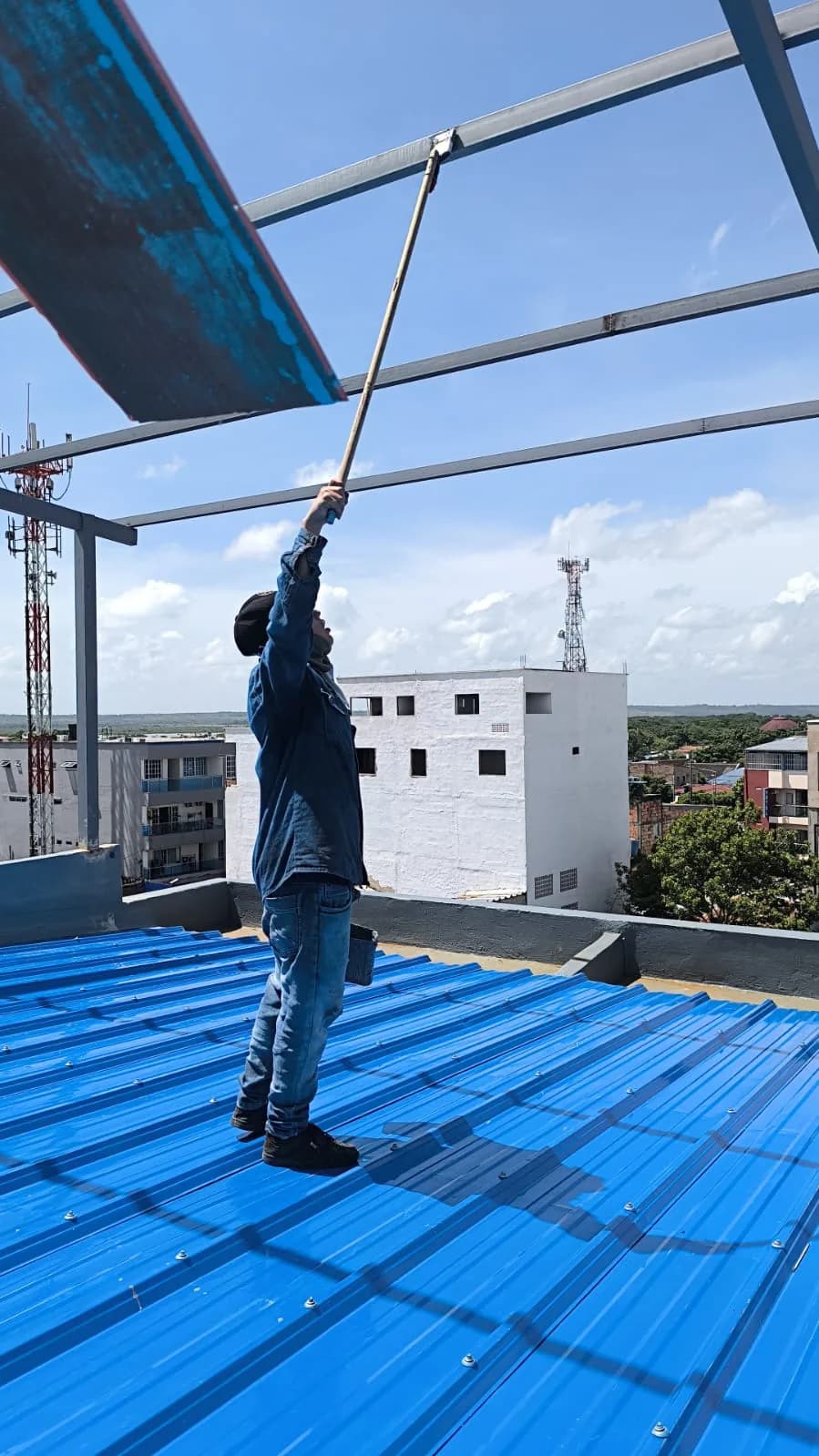Cubierta terminada en teja traslúcida azul sobre la terraza del último piso.