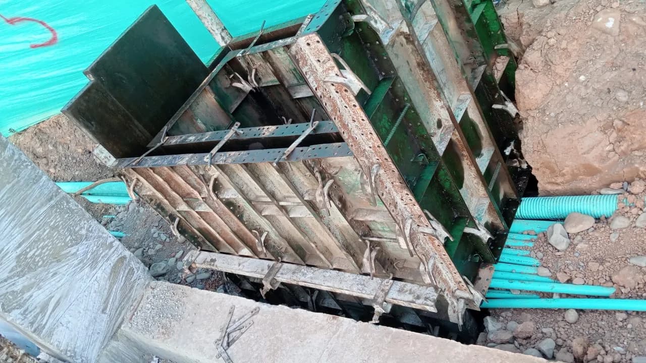 Banco de ductos de PVC entrando a la cámara de inspección todavía en formaleta metálica.